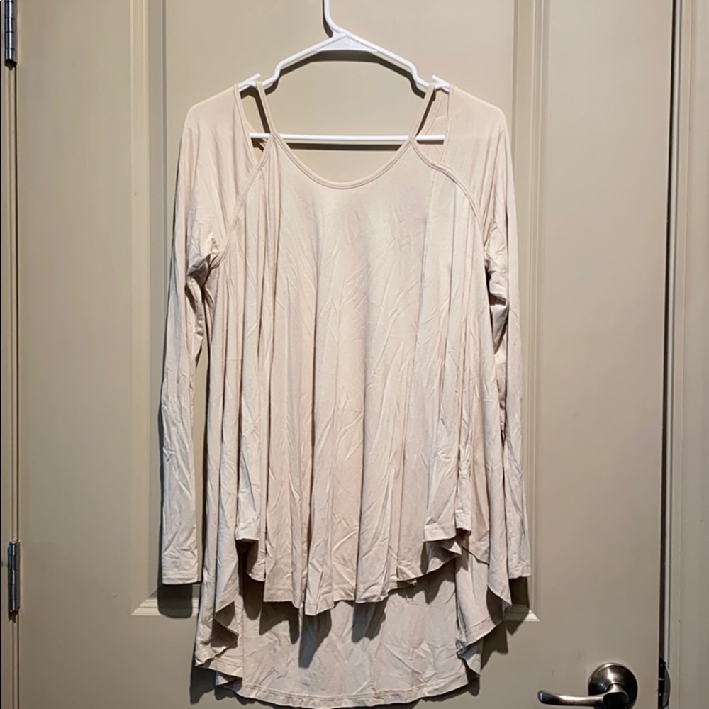 Cream colored flowy hi-low top with cutouts
